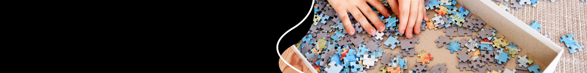 A hand putting some puzzle pieces