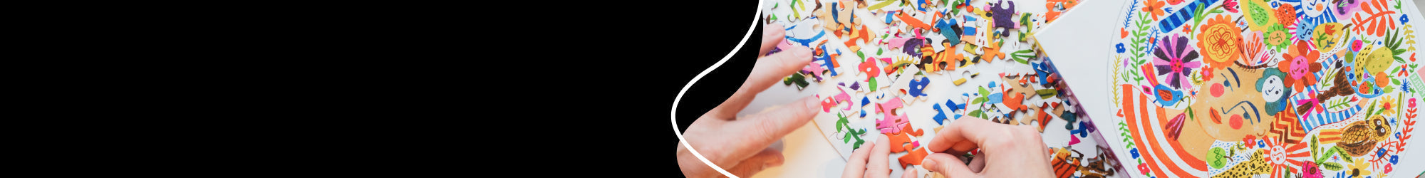 A hand putting some puzzle pieces